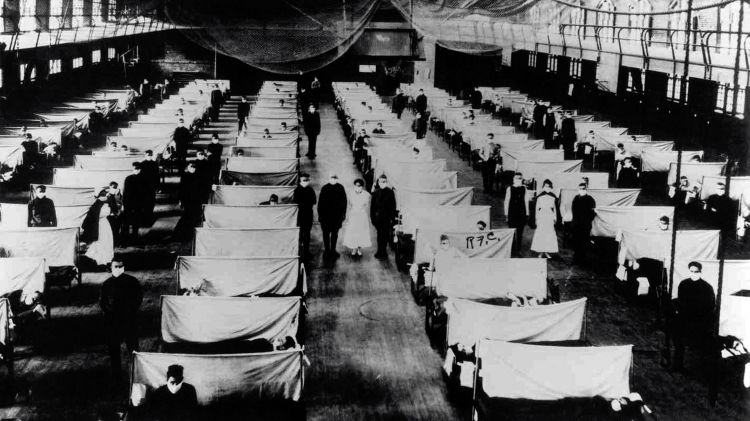 Rows of patients in beds in an isolation barracks during the 1918 pandemic.