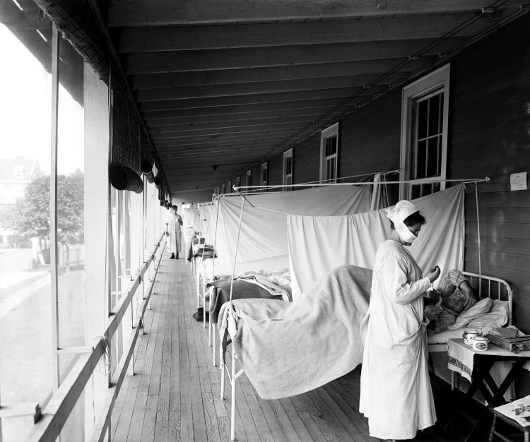 A nurse tends to a patient during the 1918 pandemic.