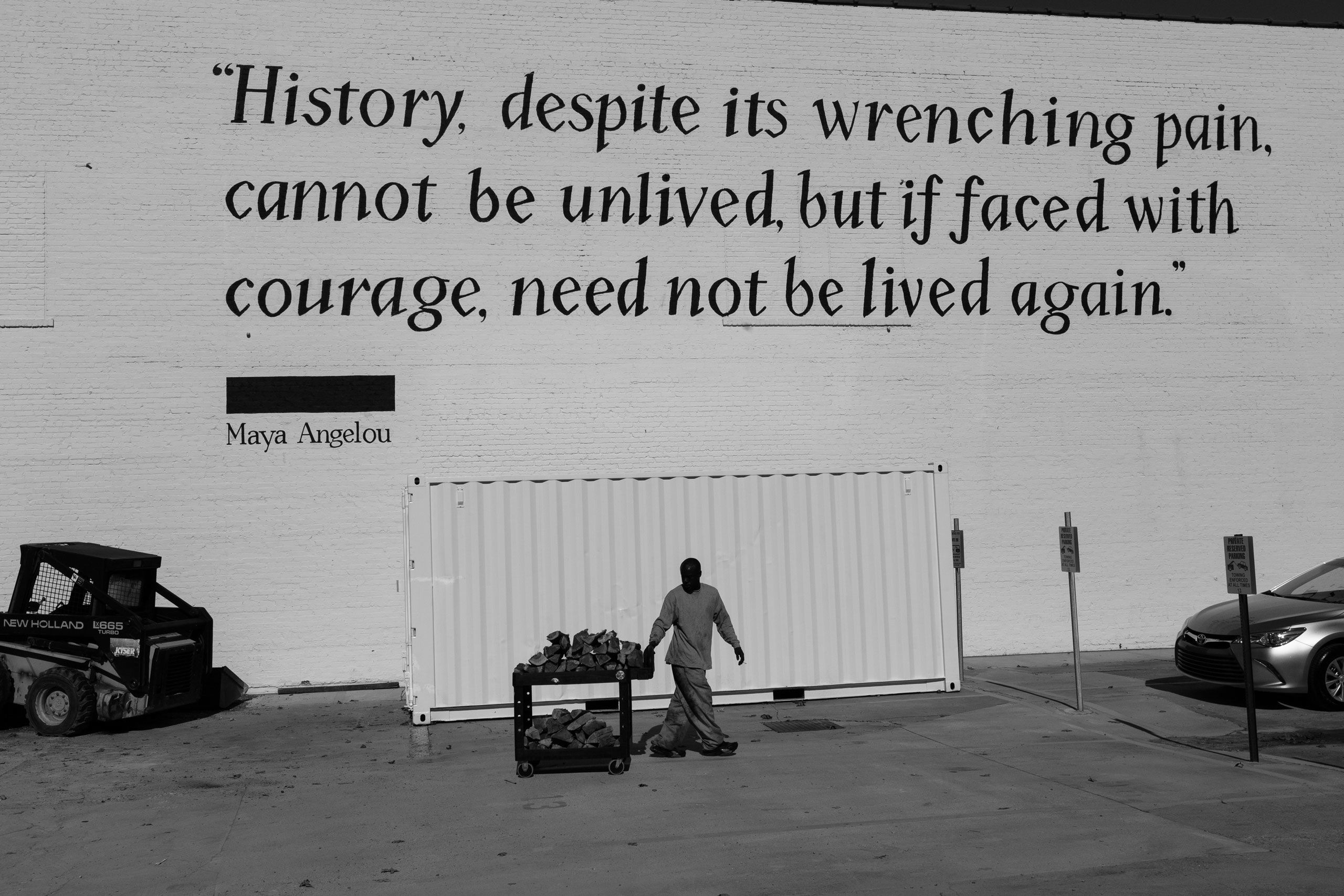 A quote from Maya Angelou is painted on the brick wall of the Legacy Museum: "History, despite its wrenching pain, cannot be unlived, but if faced with courage, need not be lived again."