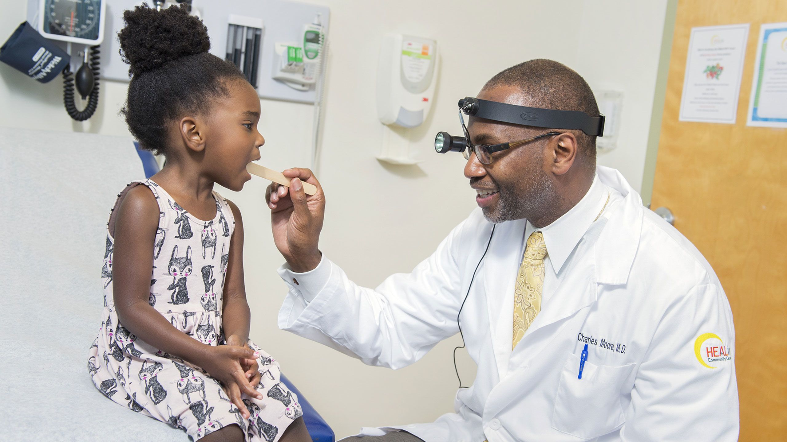 Charles Moore examines a young patient at the HEALing Community Center