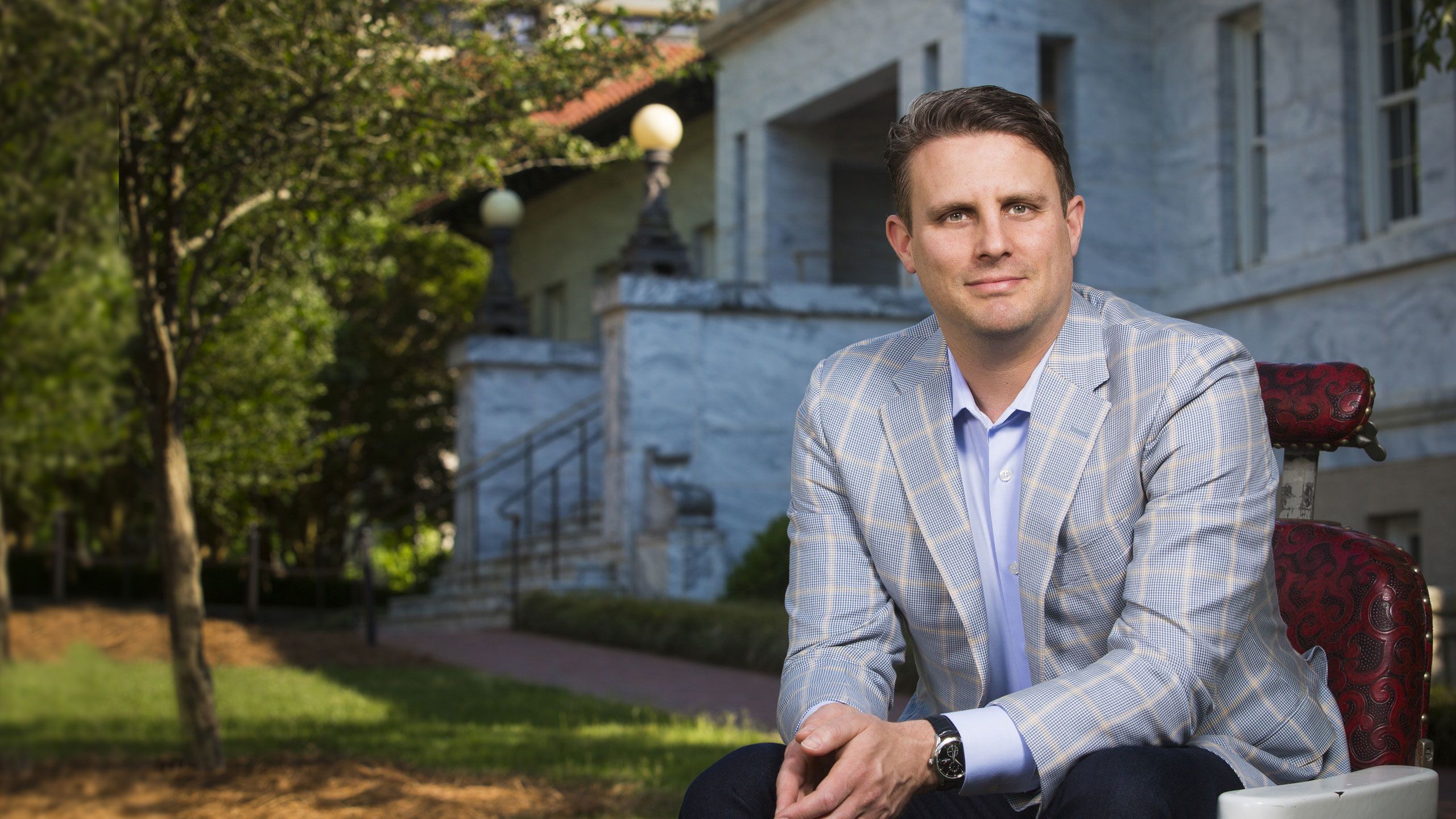 Michael Dubin sits in a barber chair on the Emory Quad