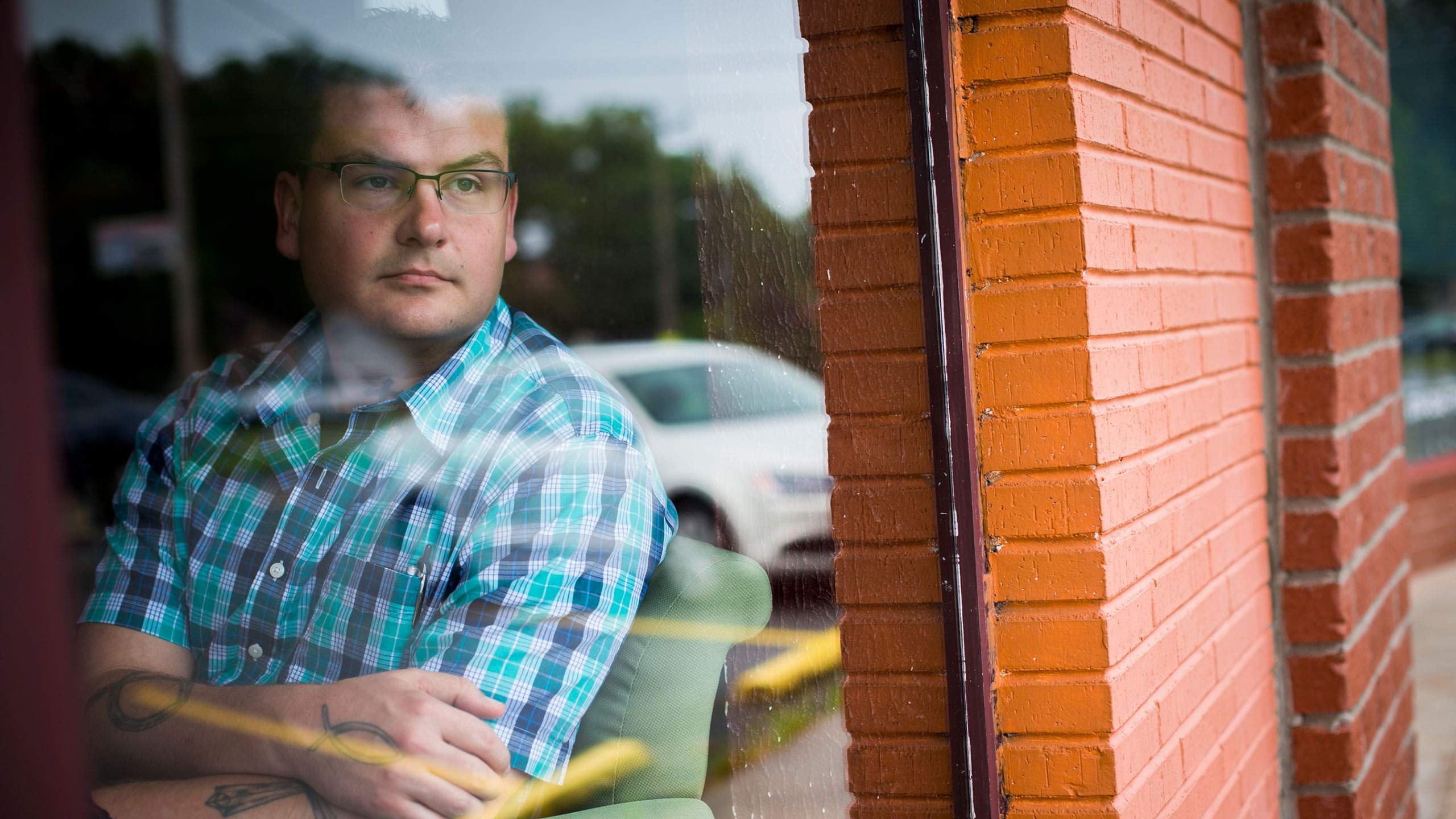 Michael Yandell looks reflectively out of a window