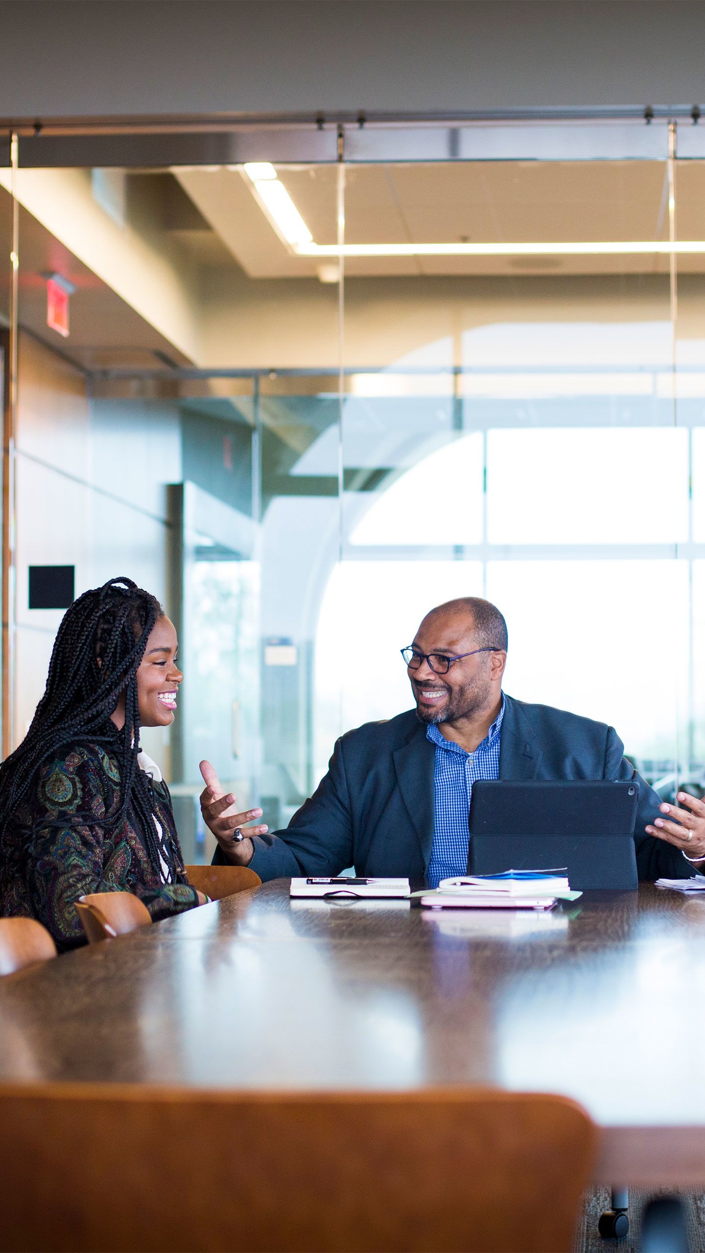 Christell Roach and Pellom McDaniels sit together at a table in Emory's Rose Library.