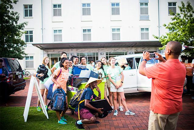 A group of brand new students pose for a photo taken by a parent at Emory's Move-In Day