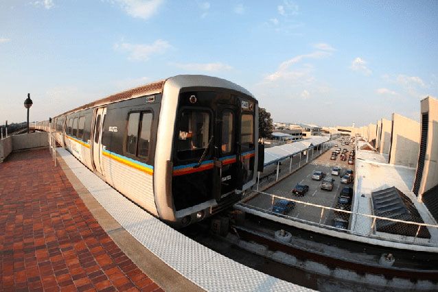 A MARTA train gliding along tracks above a busy street