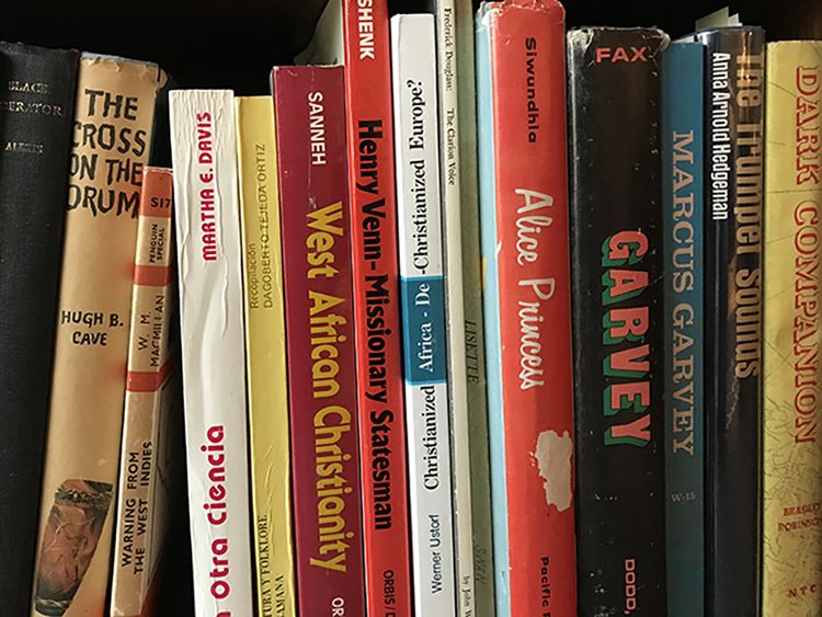 A shelf full of books on Marcus Garvey in Burkett’s library