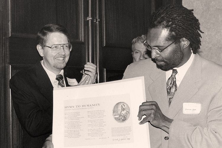 Burkett stands behind and to the left of Rudolph Byrd