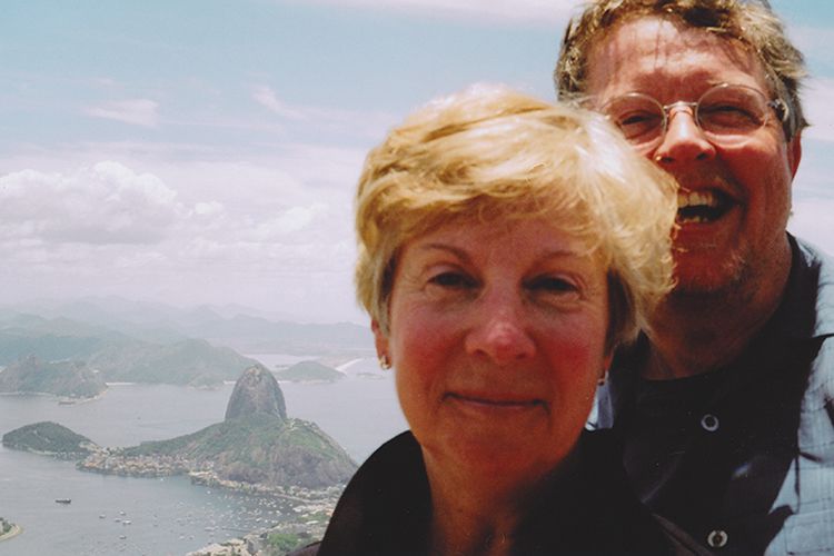 Burkett and his wife Nancy smiling with a view of Rio de Janeiro in the background