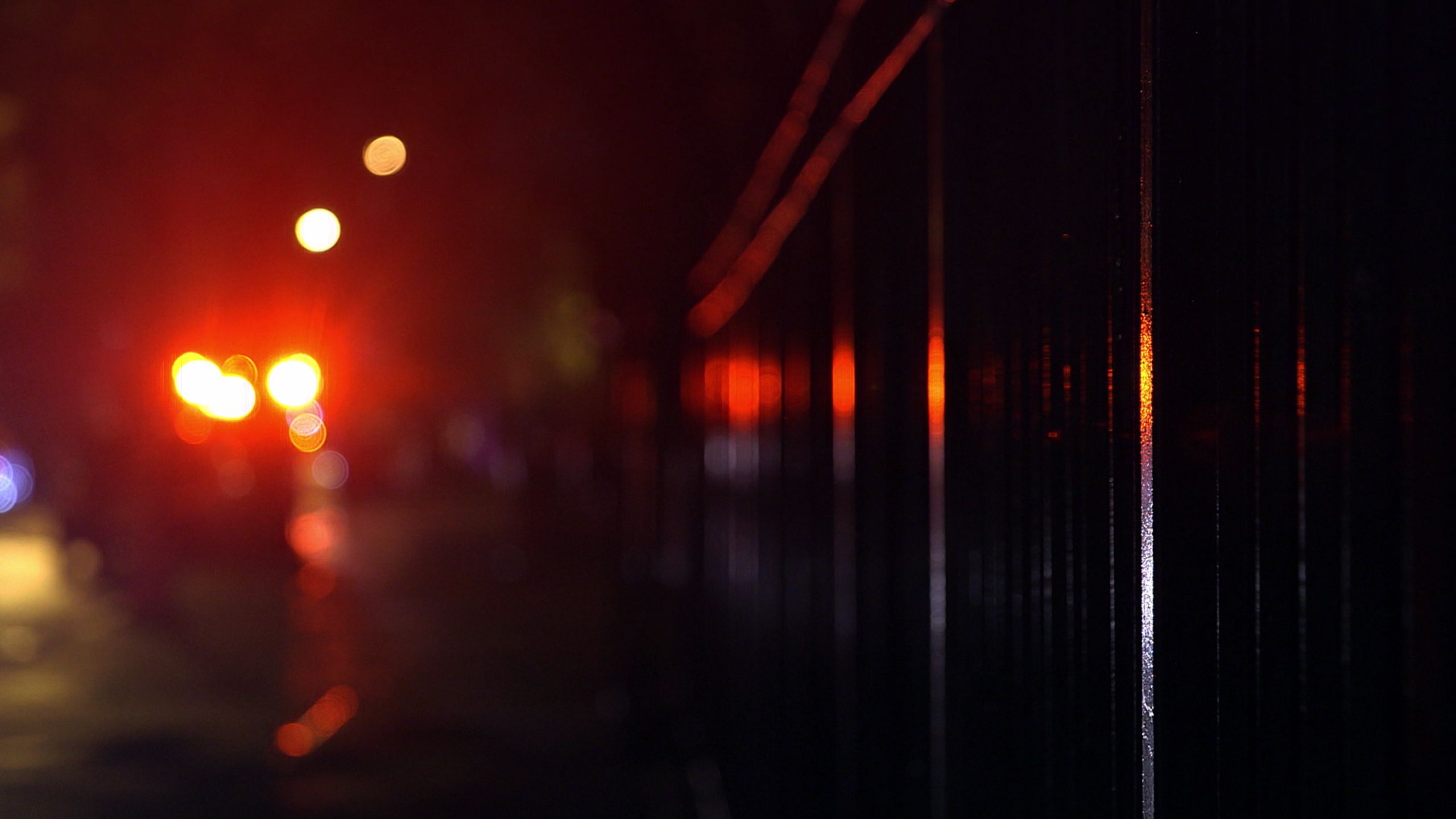 Blurry red lights that look like an emergency vehicle at an accident scene.