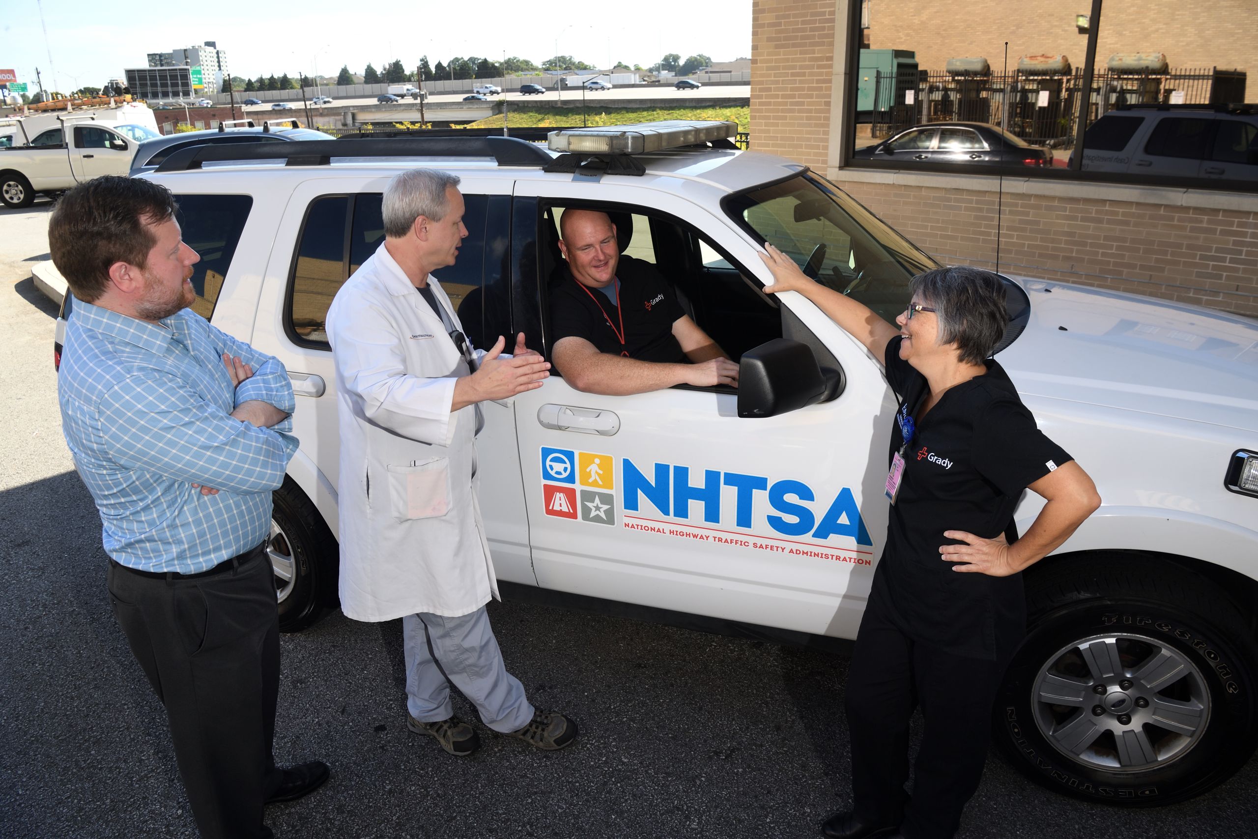 CIREN investigators gather around a National Highway Traffic Safety Administration vehicle.