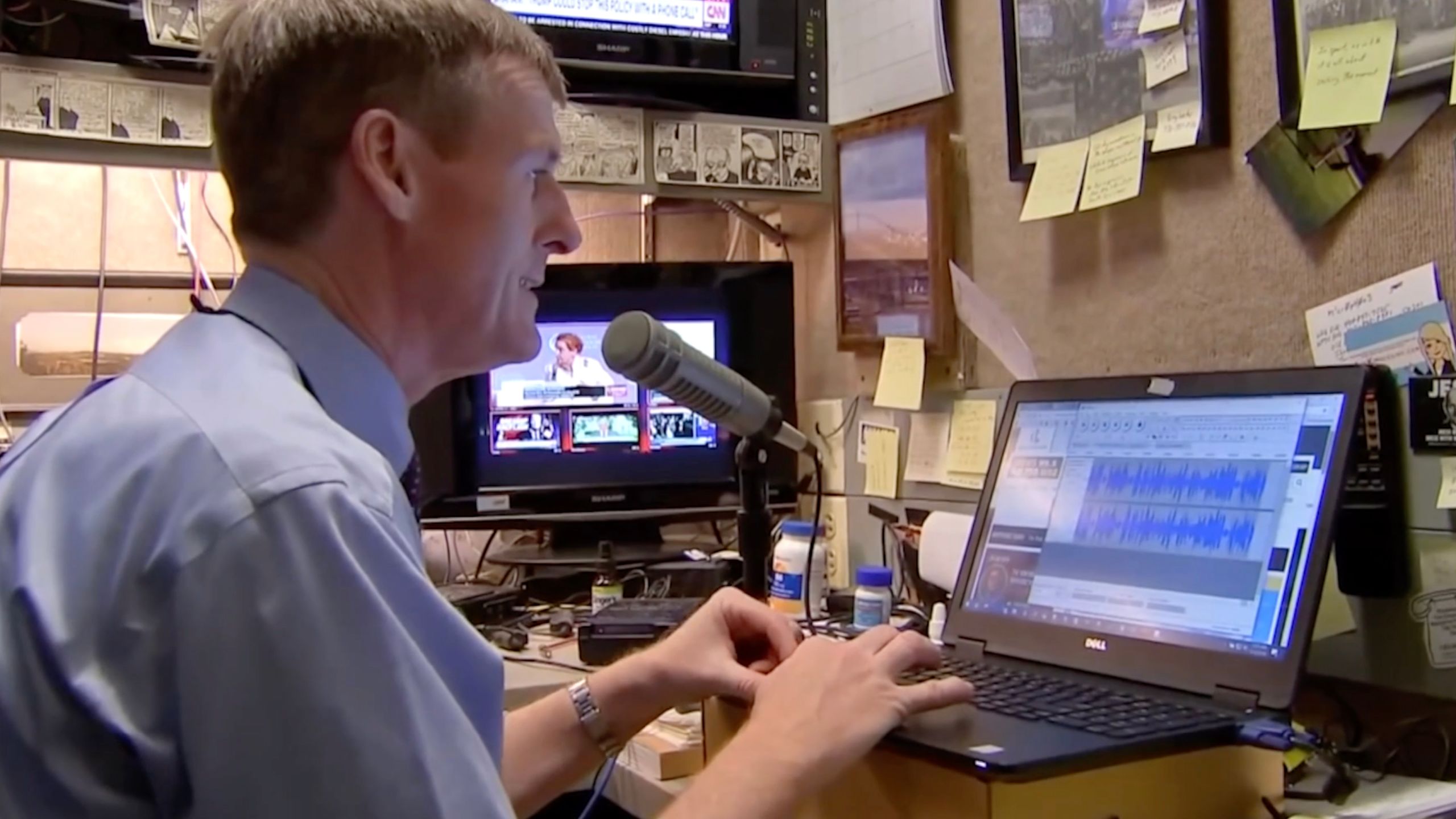 Political broadcast journalist Jamie Dupree working in Cox headquarters.