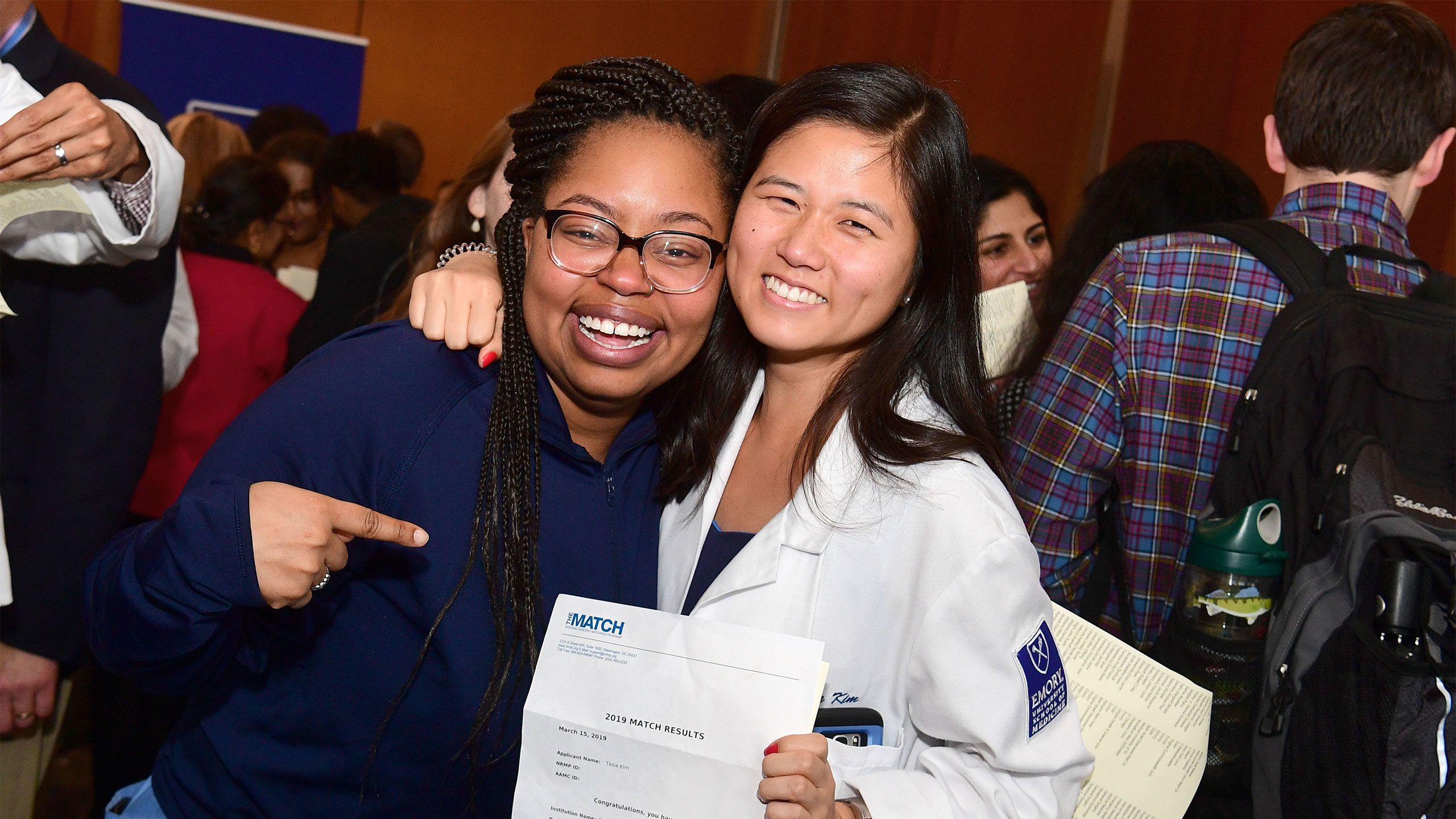 Hugging students show their Match Day results.