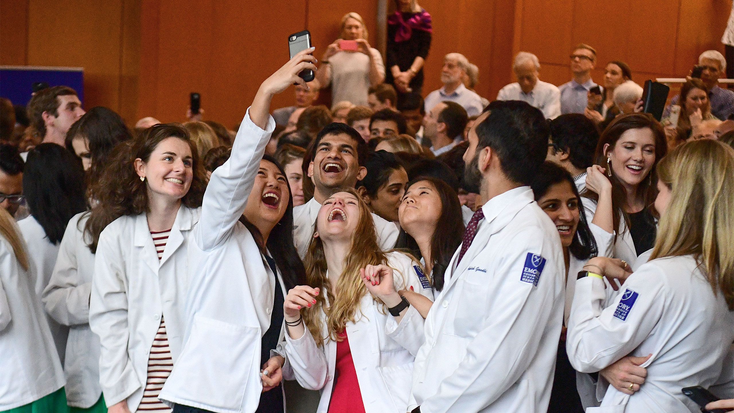 Smiling students pose for a selfie on Match Day.