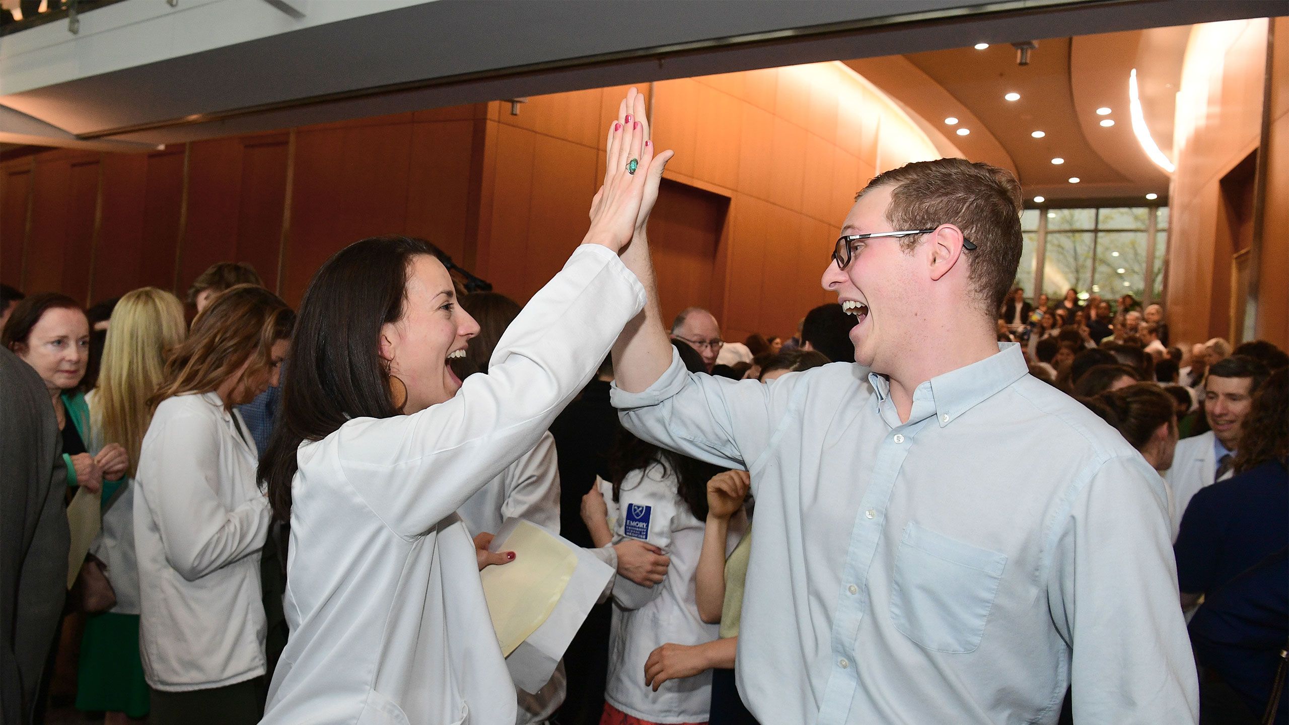 Students high five on Match Day.