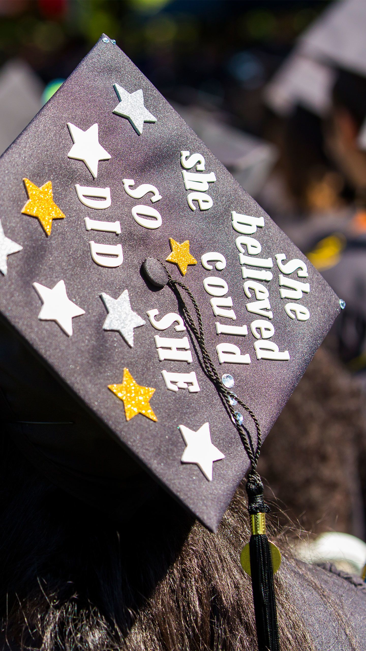 A graduation cap says "She Believed She Could So She Did"
