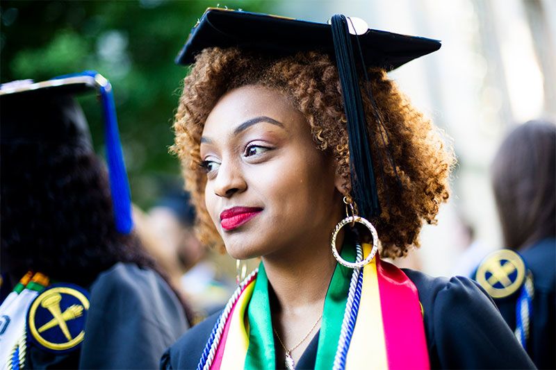 A graduate wearing a bright stole