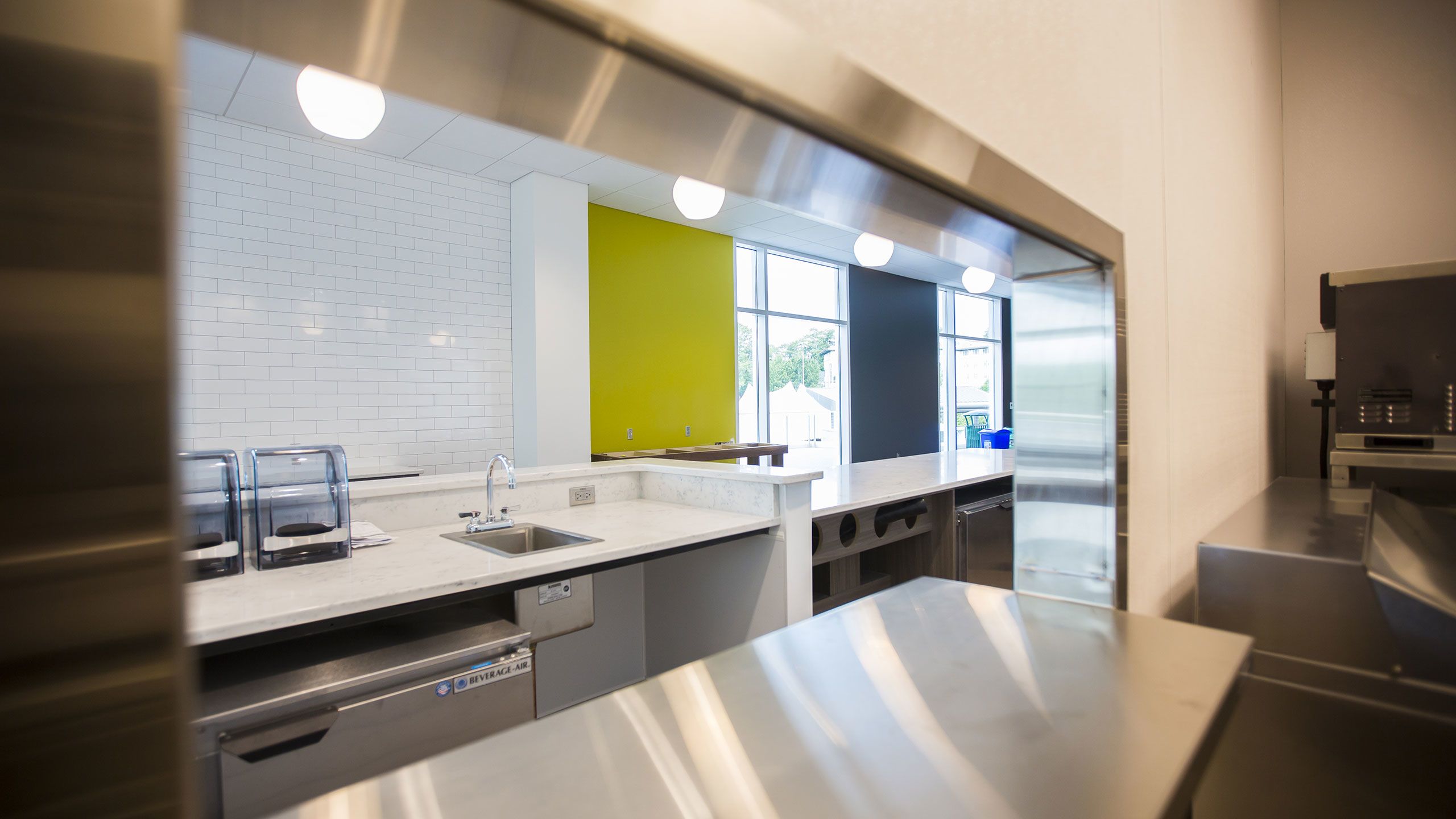 A view of a kitchen a beverage refrigerator