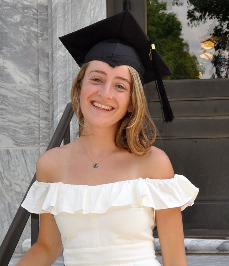 Isabel Goddard wearing a graduation cap and smiling