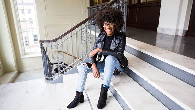 Mawuko smiling and sitting on the steps