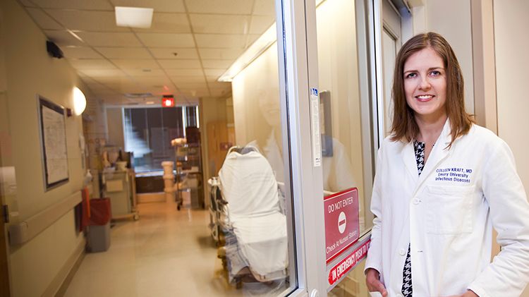 Colleen Kraft standing in front of isolation ward hallway