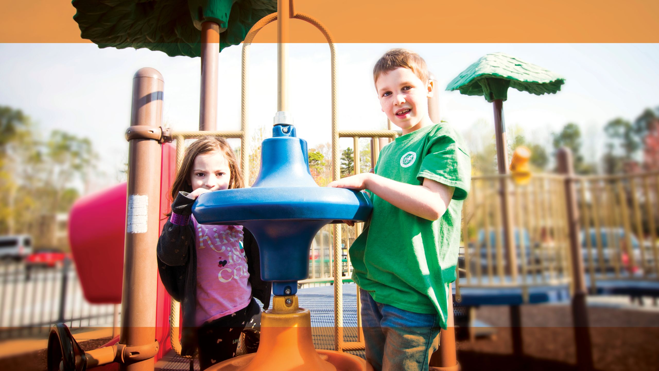 Amiel and Elise playing together in a playground.