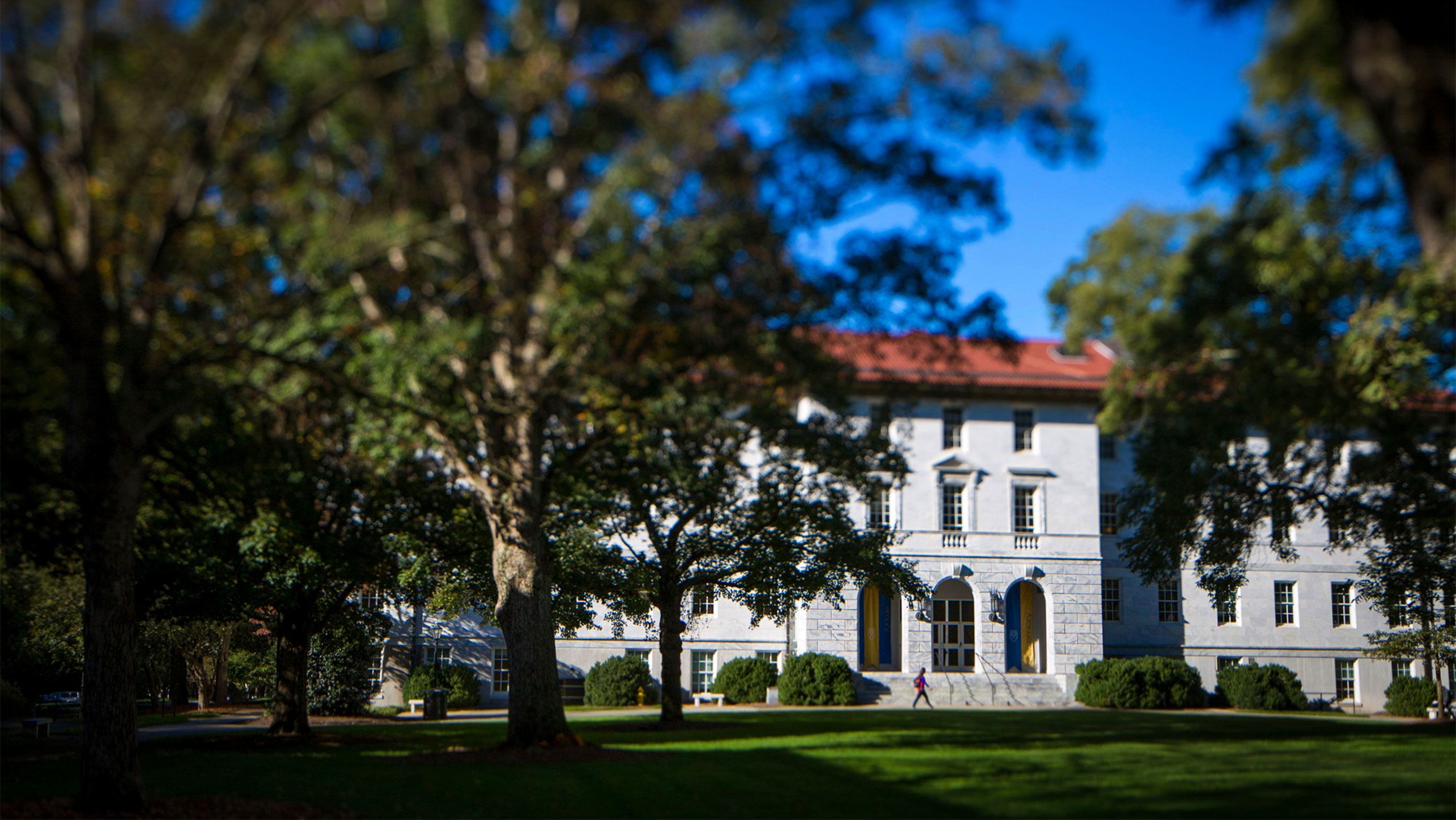 Students walk in front of the administration building on the main Emory Quad