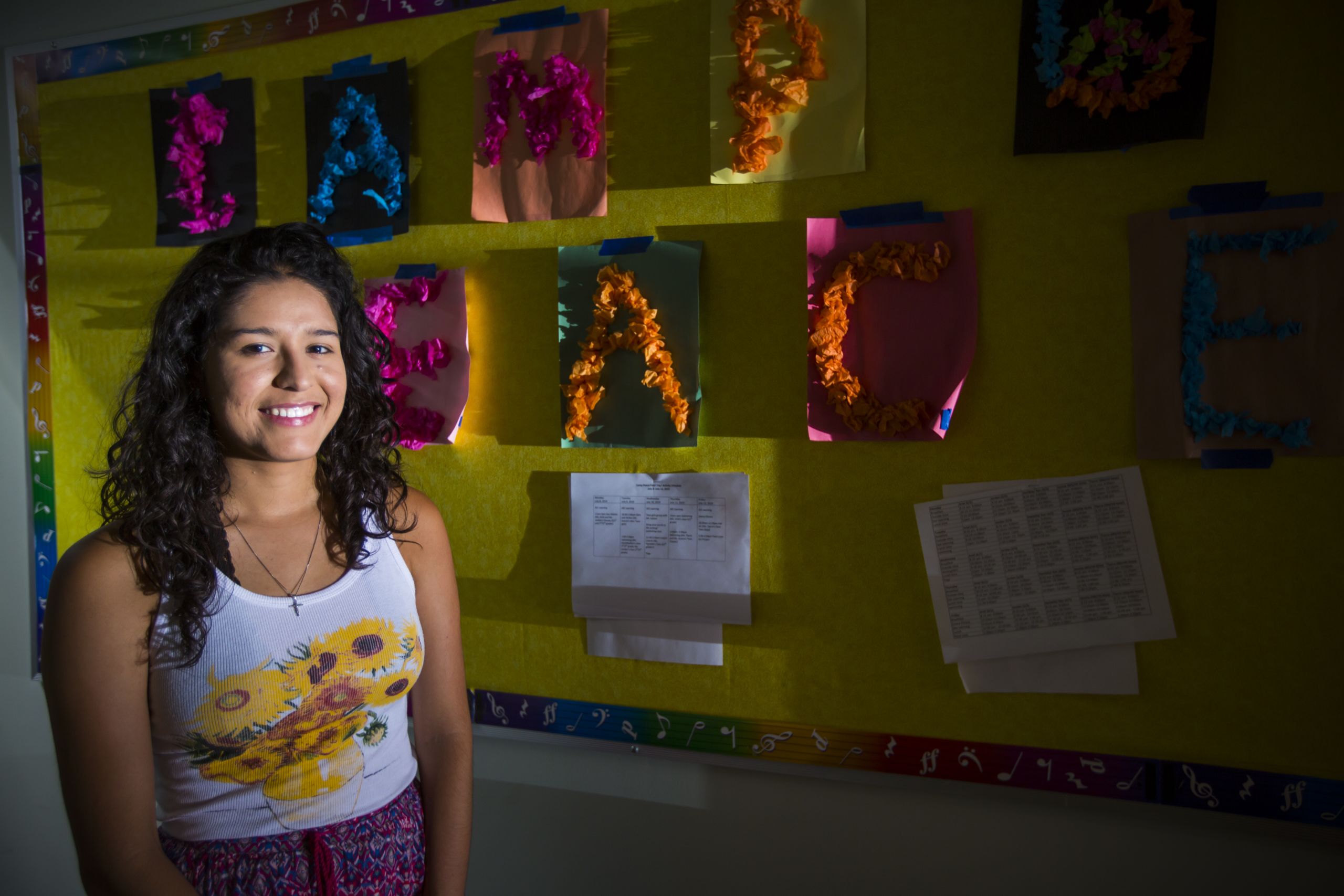 Emory student stands outside the classroom where she volunteered during the summer