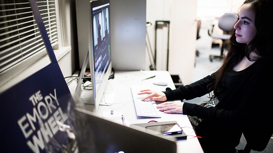 Student at computer working on the Emory Wheel