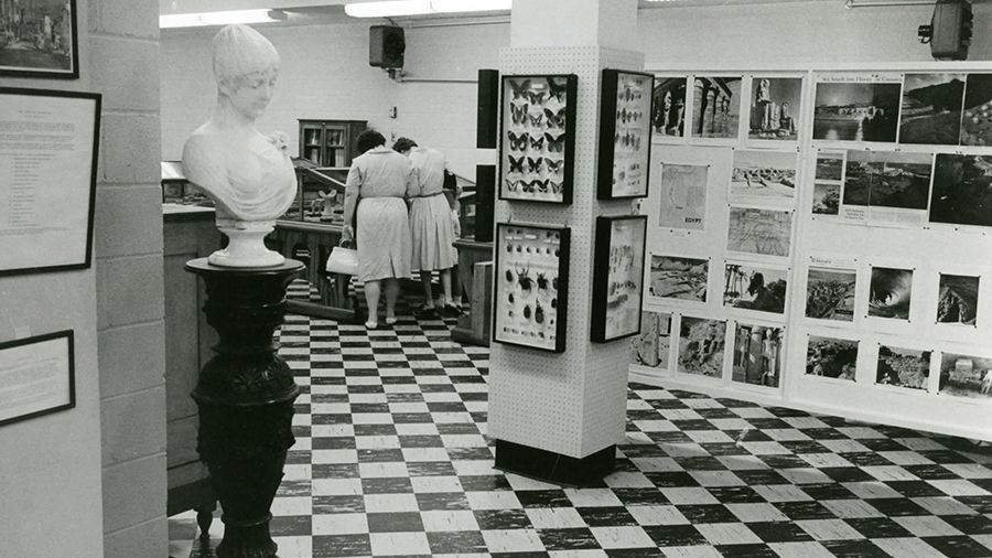 Two women looking at artifacts in Bishops Hall