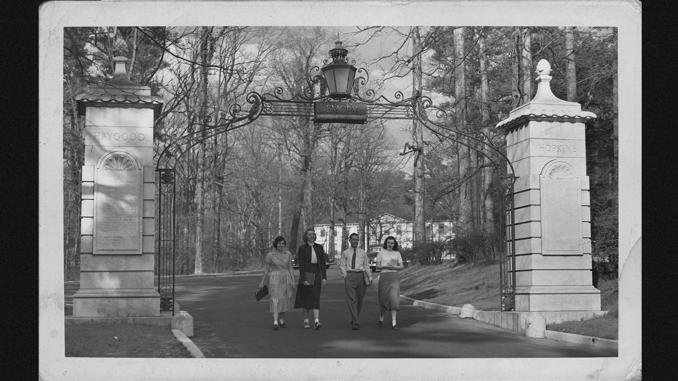 students walking through gate driveway