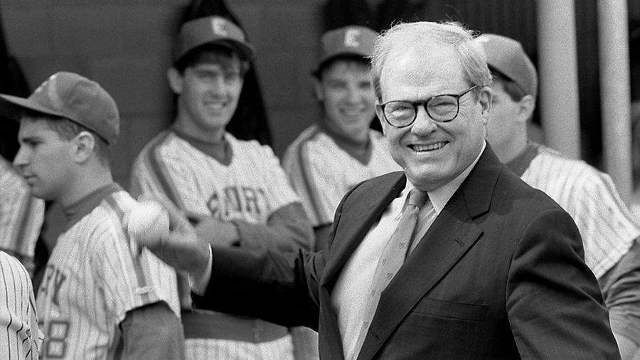 James Laney throwing a baseball with players in background
