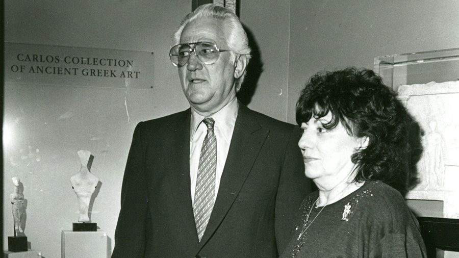 Thalia and Michael C. Carlos standing in museum in dress clothes.