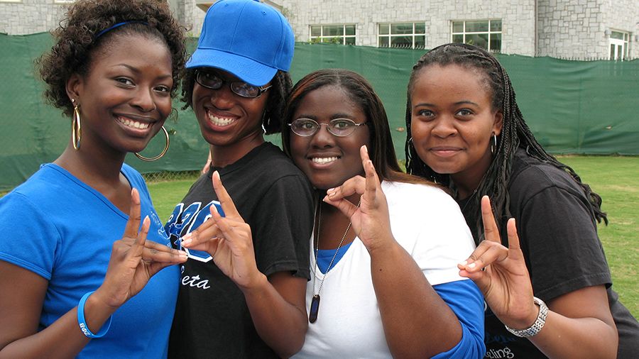 A group of four African American sorority sisters from Zeta Phi Beta.