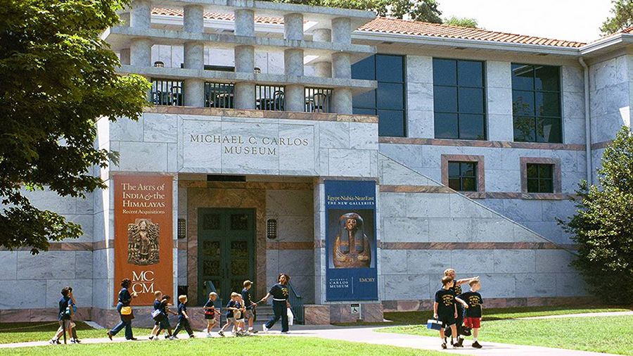 Summer campers walk in front of the Michael C. Carlos Museum