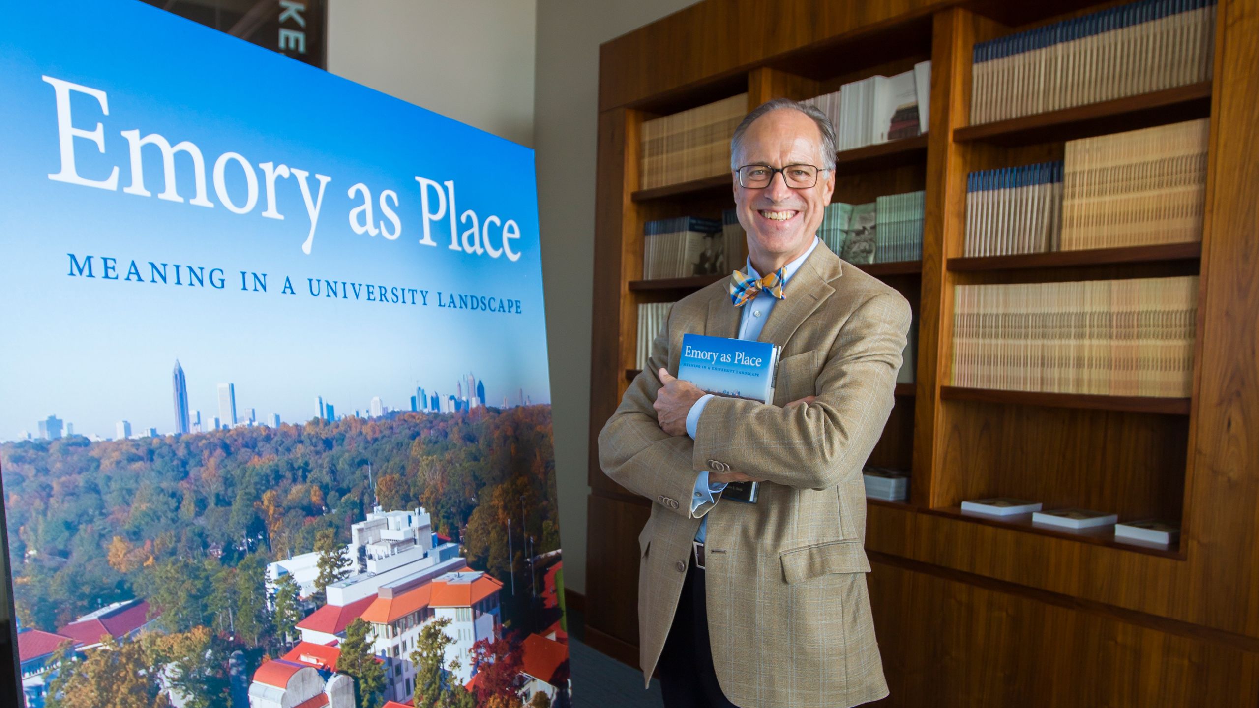 Gary Hauk hold his book "Emory as Place" in Rose Library