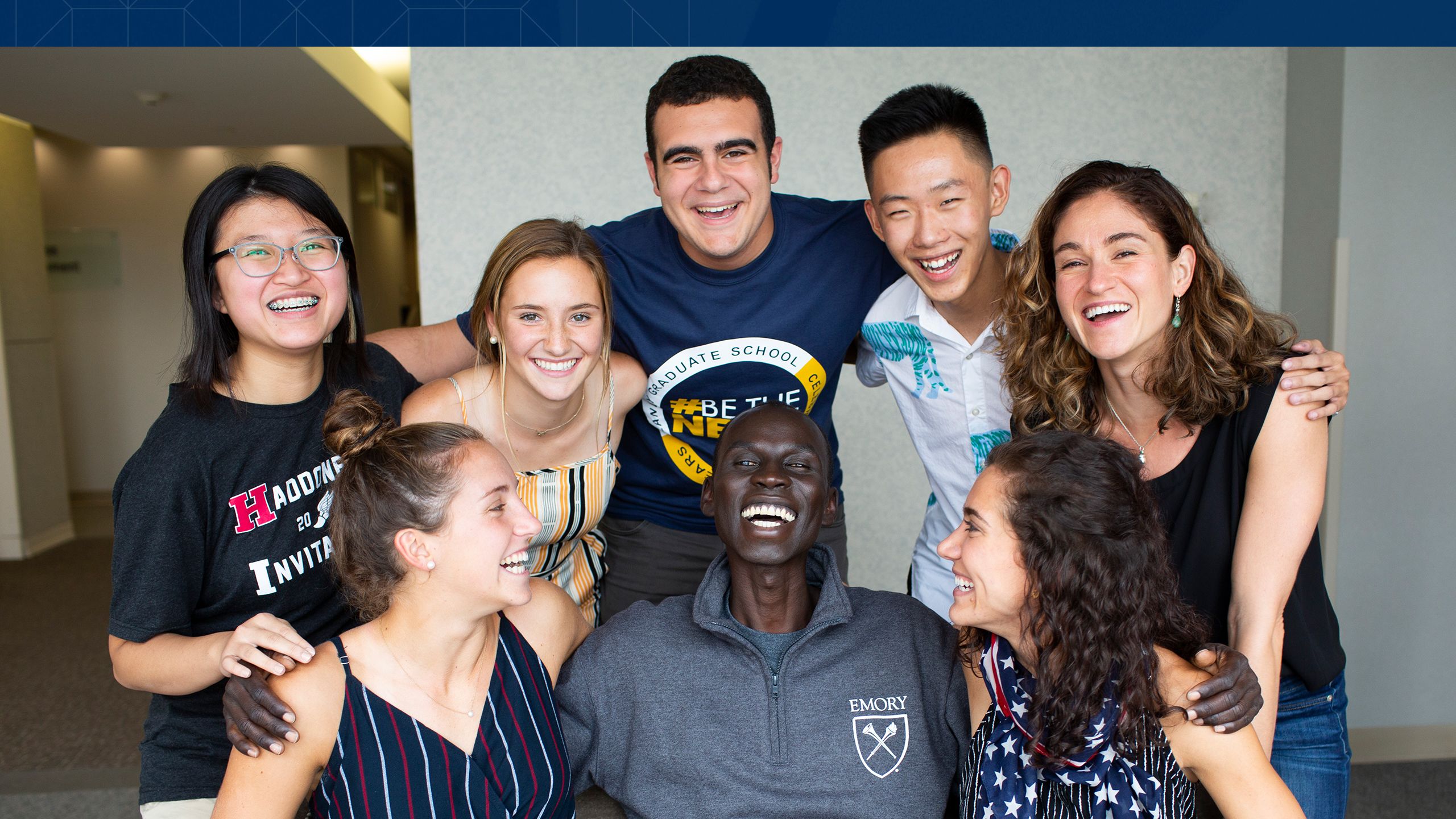 Buk Buk laughing with a colleague, high school students and their teacher.