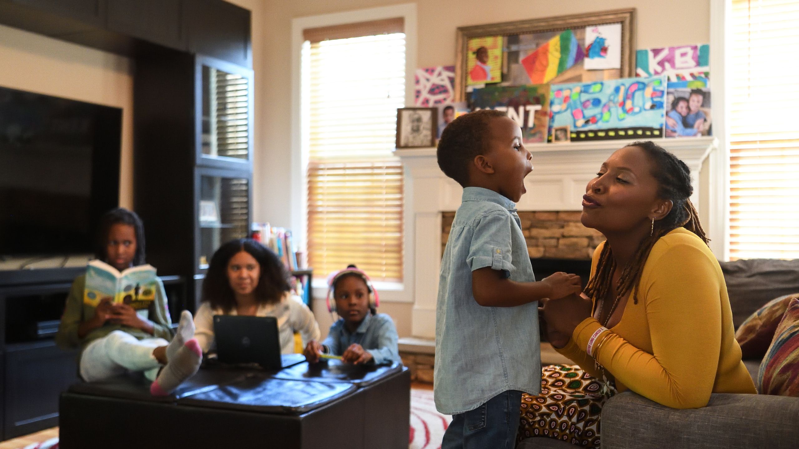 Daughters Karsyn, Amelie and Gabrielle look on as their brother Kent preparing to give his mother a kiss. 