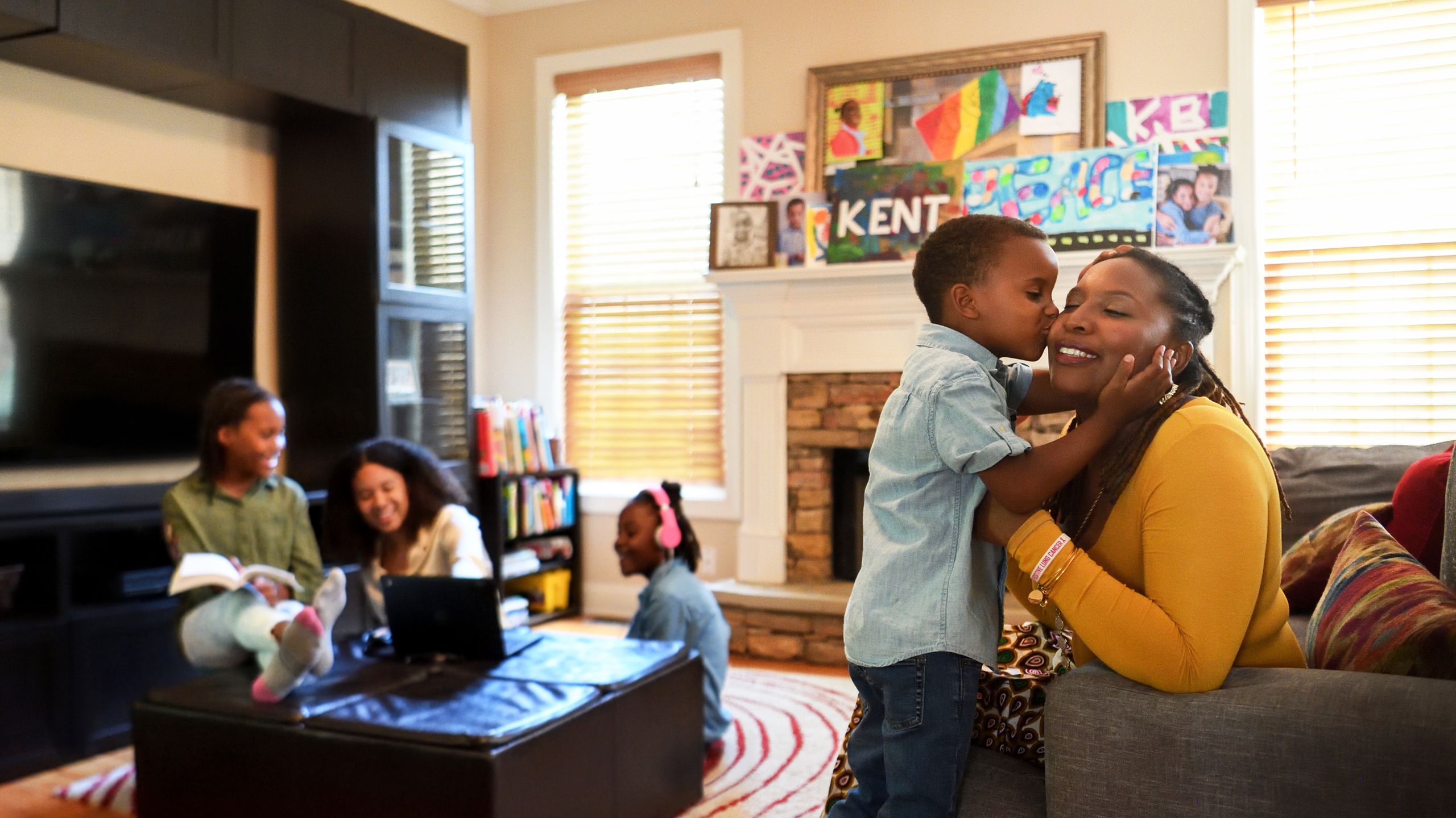 Daughters Karsyn, Amelie and Gabrielle look on as their brother Kent give his mother a kiss. 