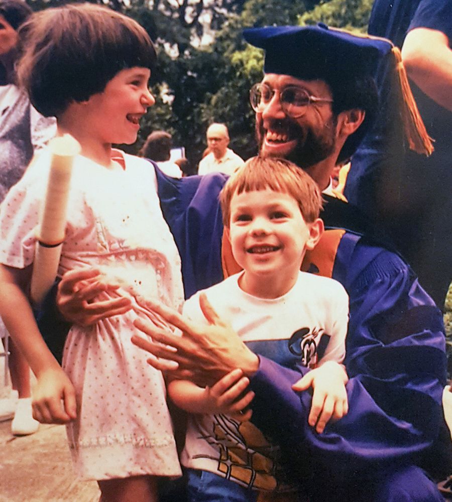 Gary Hauk in graduation regalia with his daughter Alexis and son Thomas. 