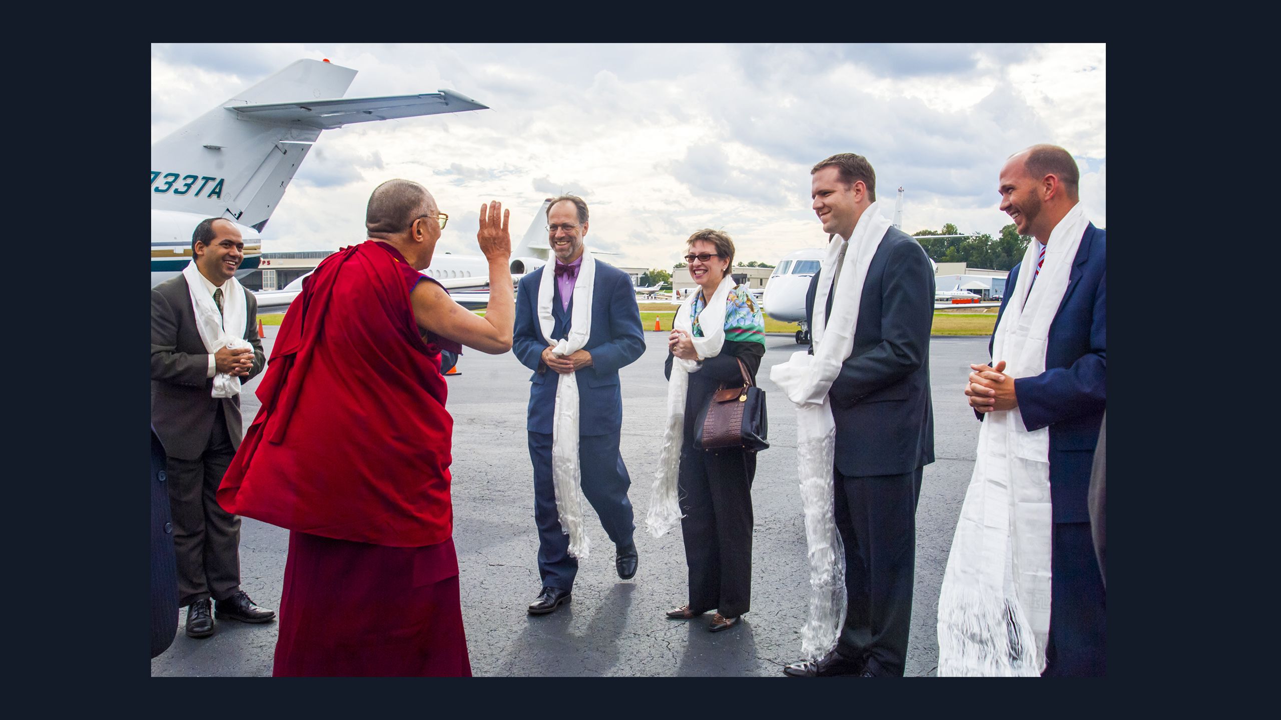 His Holiness the Dalai Lama being welcomed at the airport by a group of Emory administrators