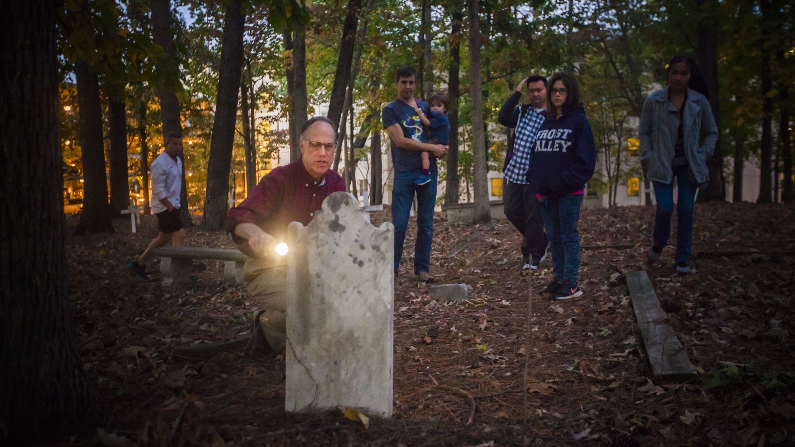 Hauk in front of a gravestone, leading a tour through Hardman Cemetery in 2016
