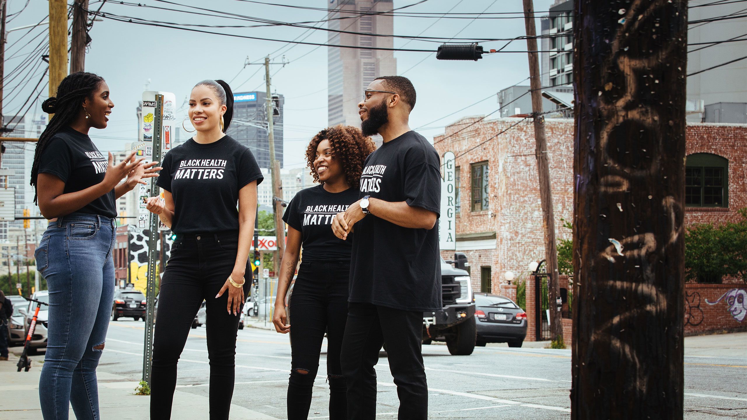 Students wearing Black Health Matters t-shirts talk in a group