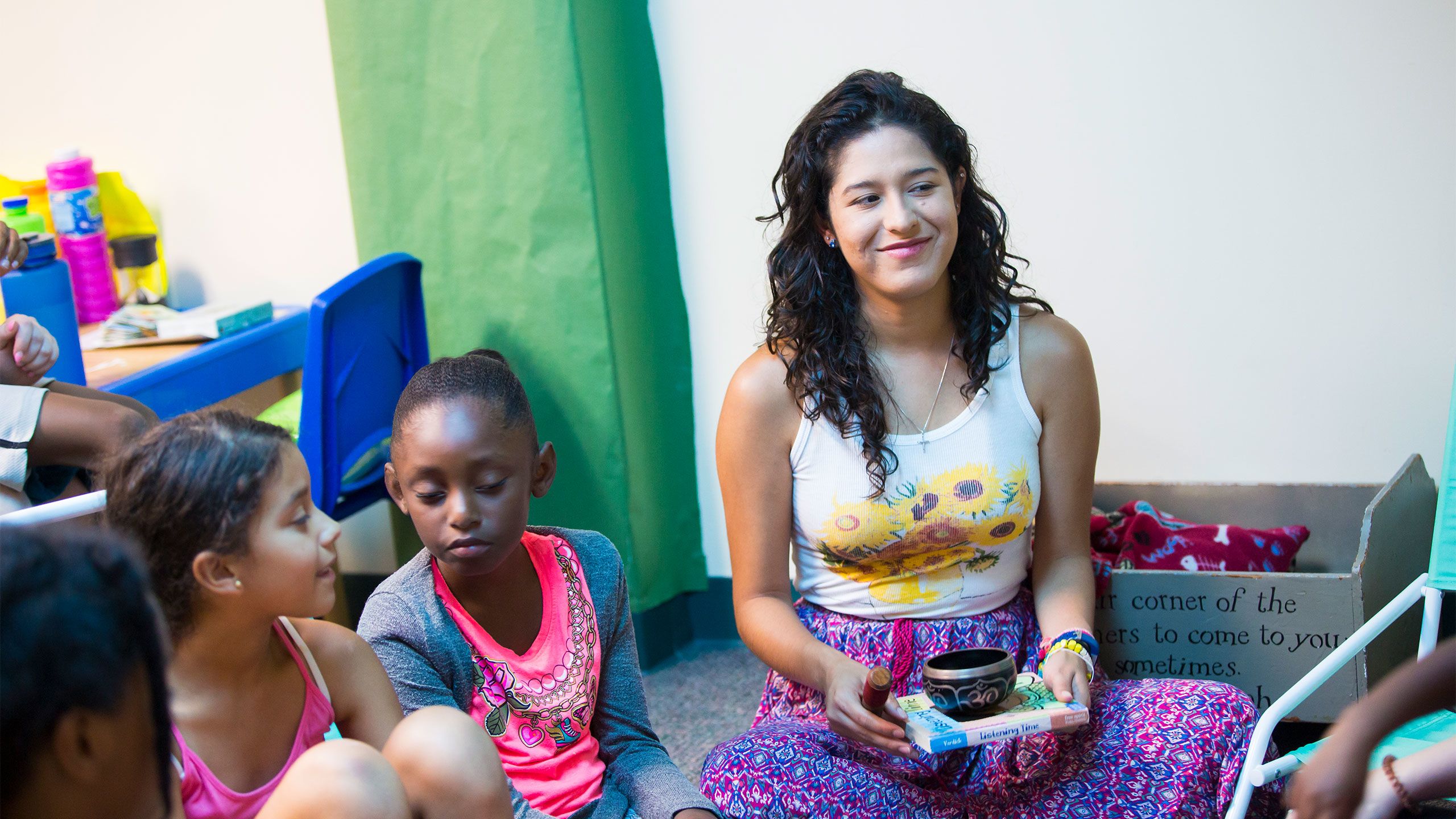 An Emory student interacts with children at Camp PEACE