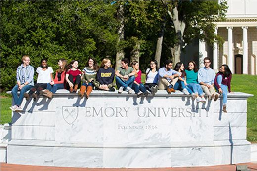 Emory students sitting on wall