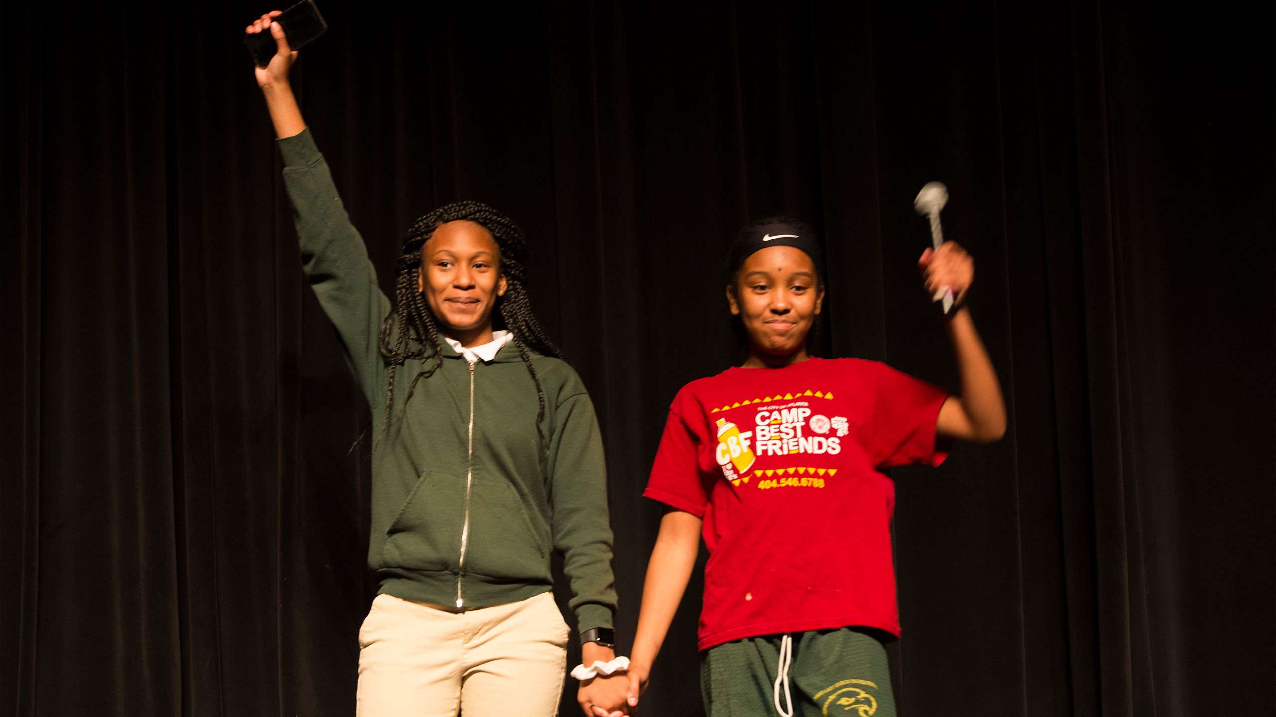 Two students on stage during the exhibit's opening night