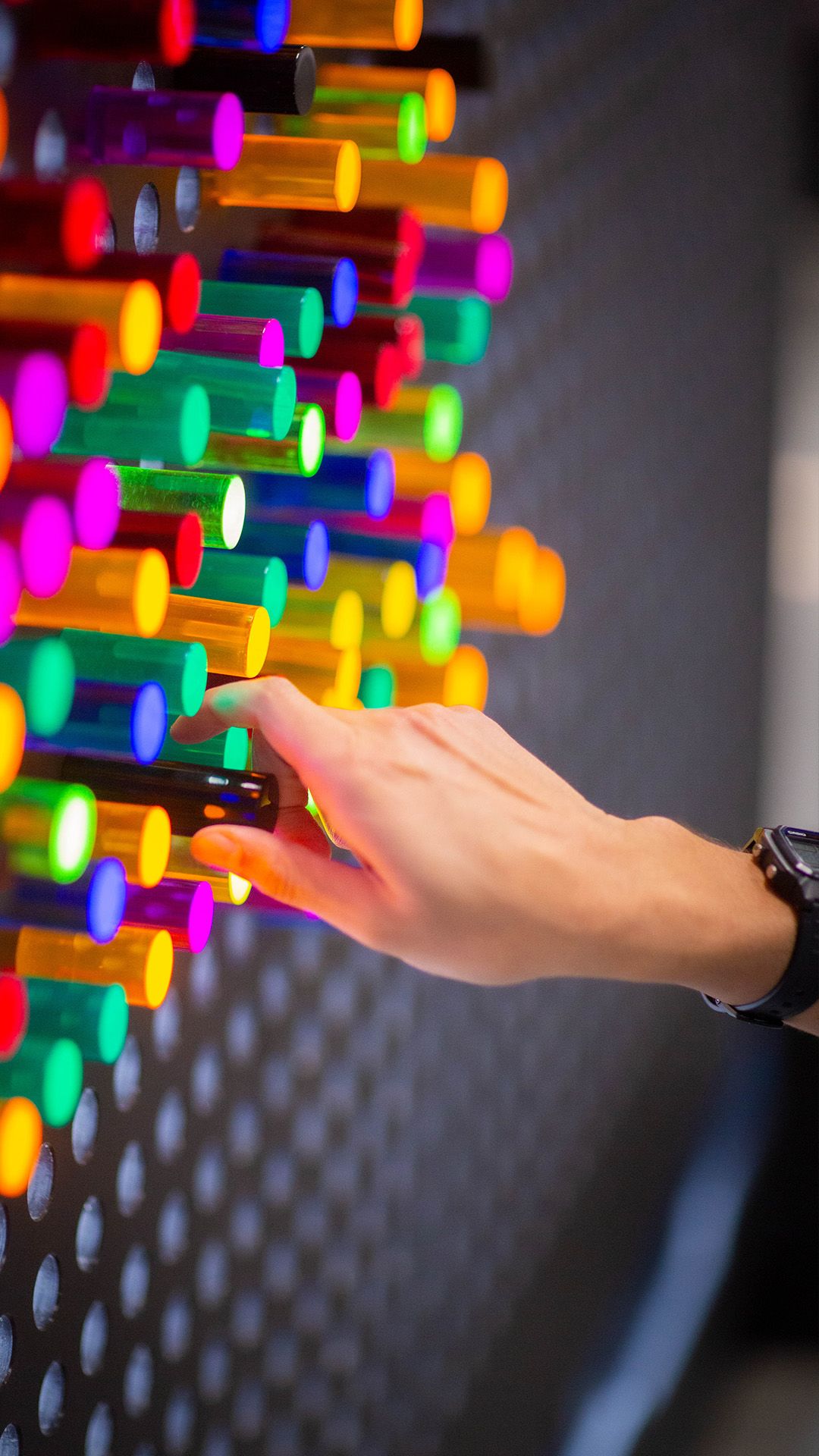 Closeup of hands using the Lite-Brite board