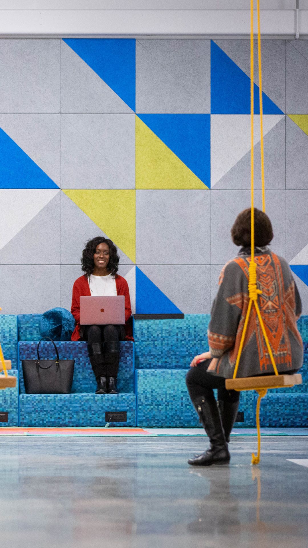 Two women in the area near the swing sets