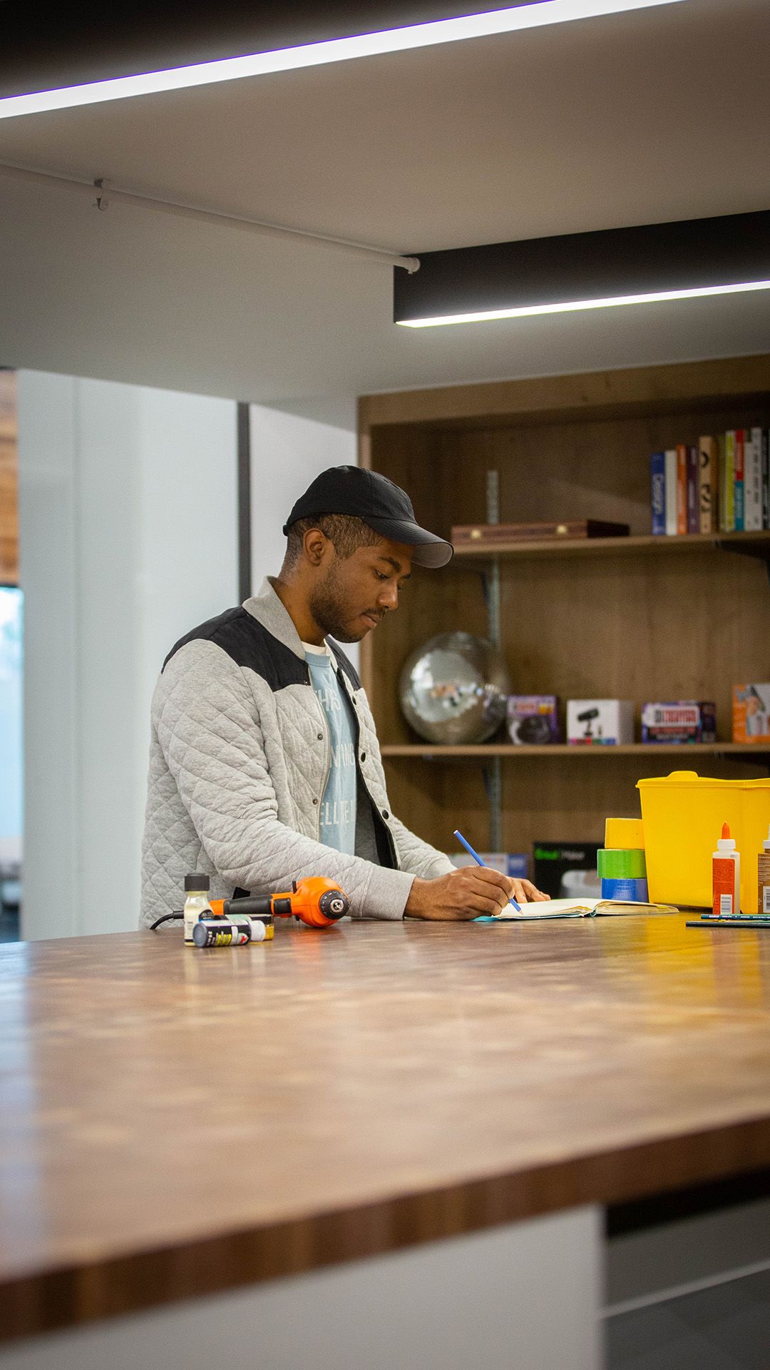 A student drawing on a pad in the makerspace area