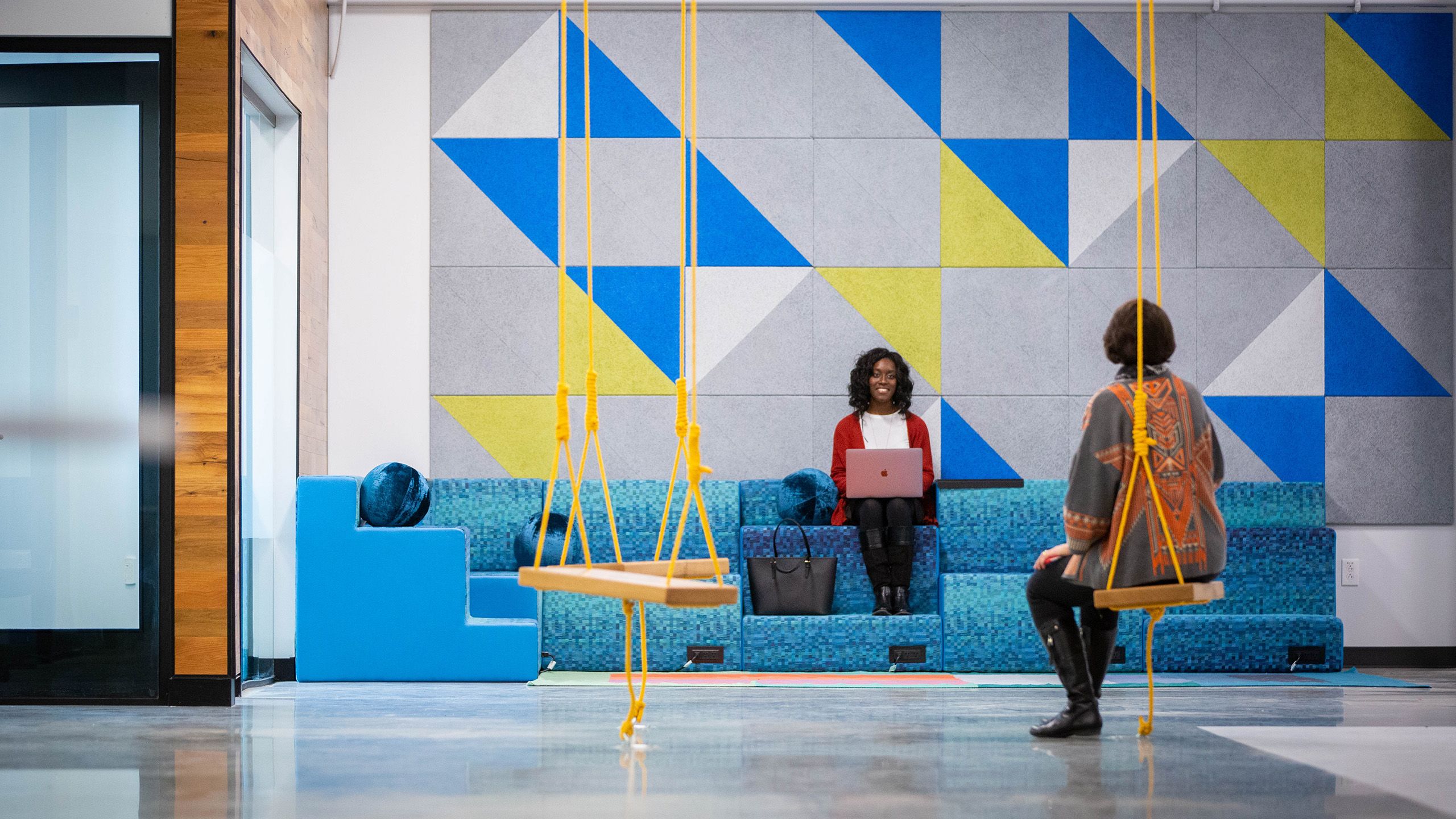 Two women in the area near the swing sets