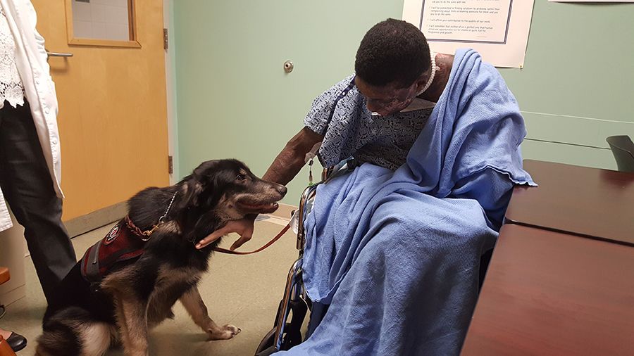 Jalen pets a therapy dog